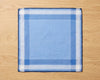 Blue and white checkered pocket square on a wooden surface