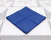 Blue folded napkin on a white tablecloth