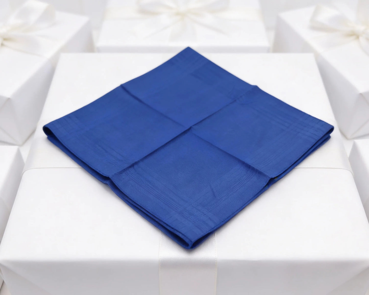 Blue folded napkin on a white tablecloth