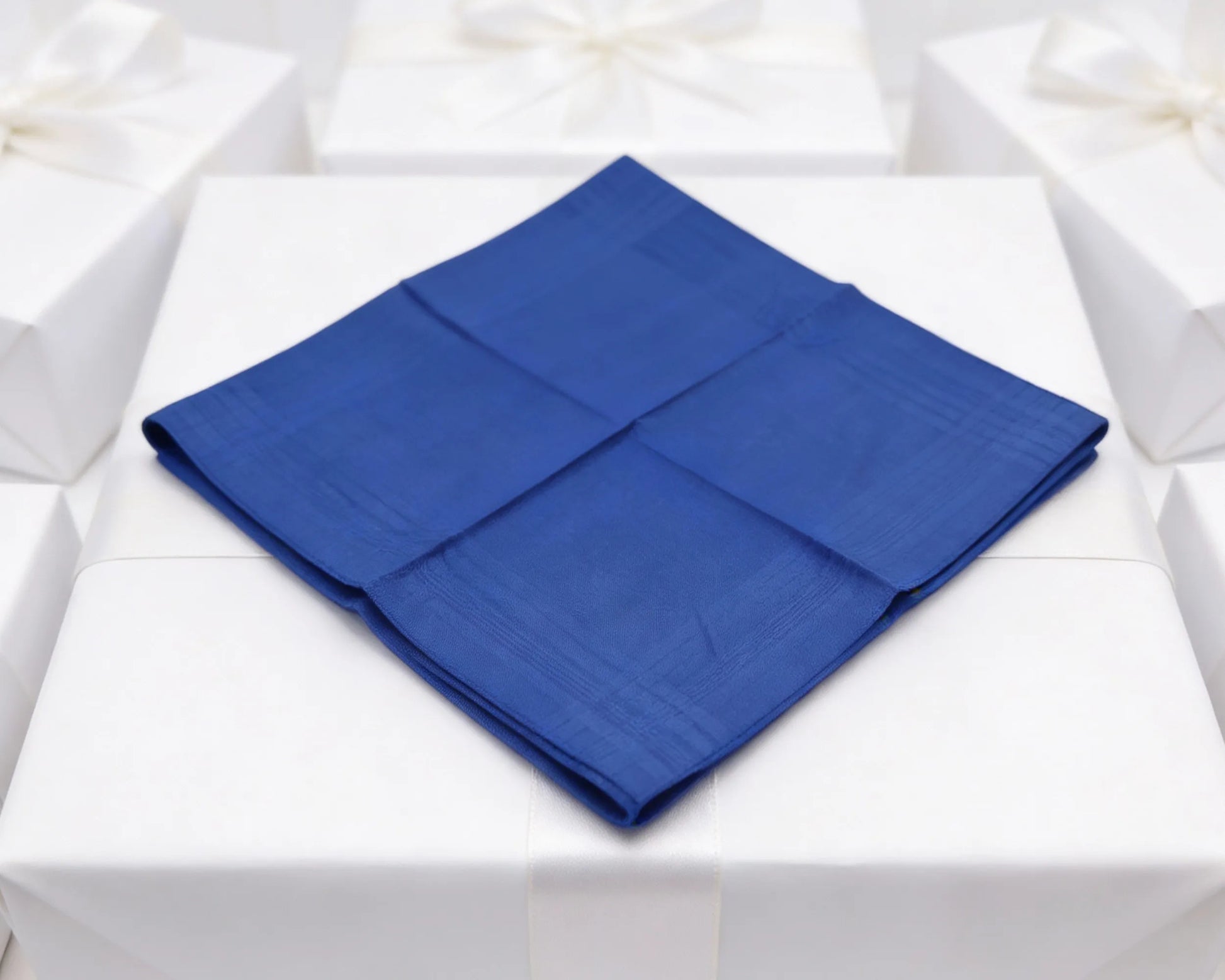 Blue folded napkin on a white tablecloth
