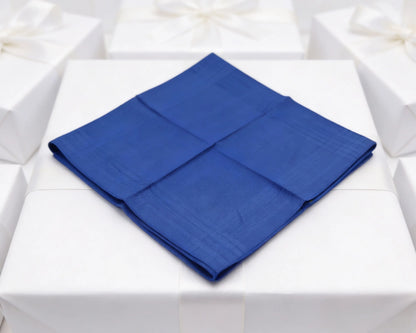 Blue folded napkin on a white tablecloth
