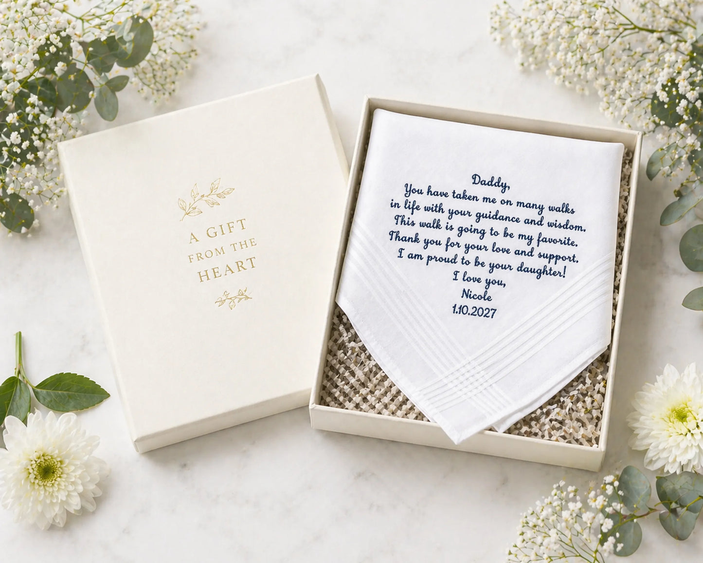 Set of pastel-colored handkerchiefs arranged in a circular pattern on a white surface with flowers.
