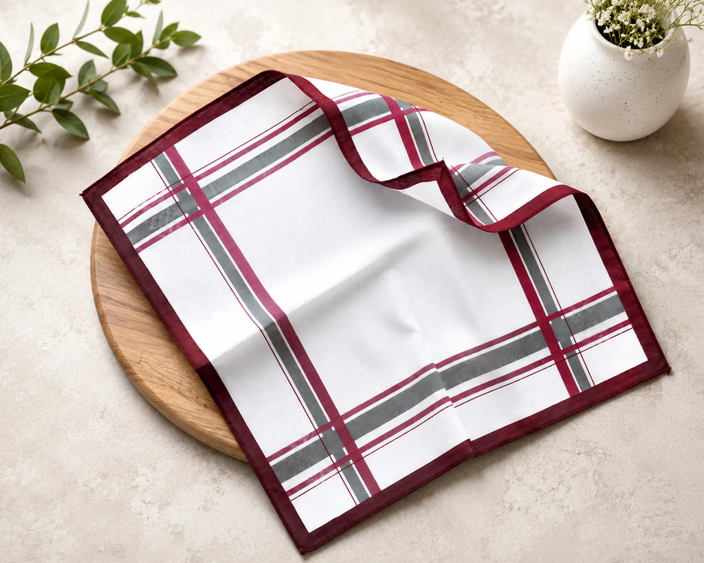 Plaid hanky on a wooden board with a plant in the background