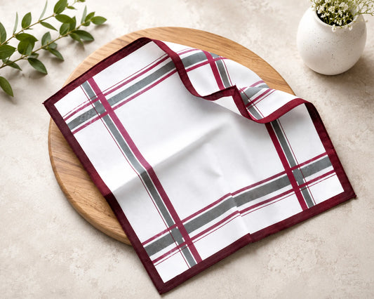 Plaid hanky on a wooden board with a plant in the background
