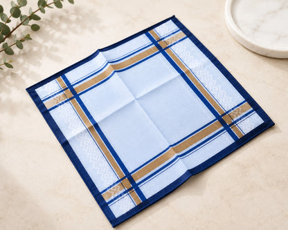 Blue checkered placemat on a light surface with a plant in the corner