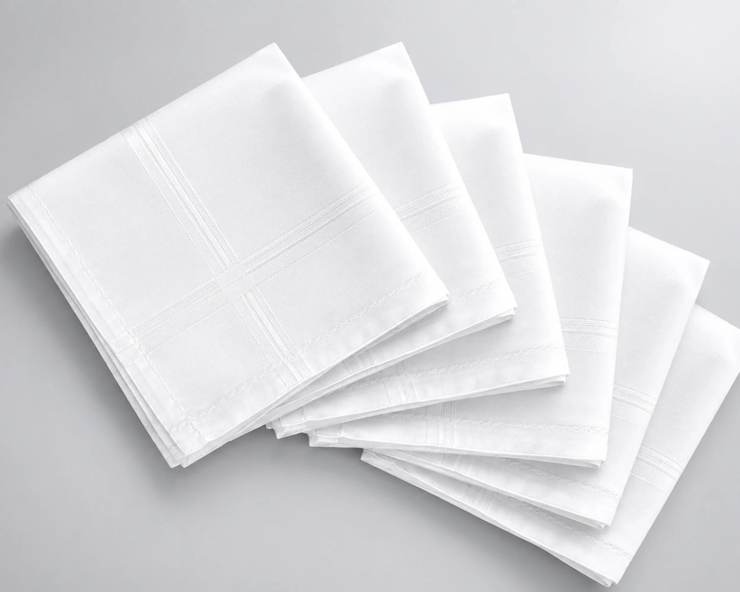 Stack of white hanky on a gray background