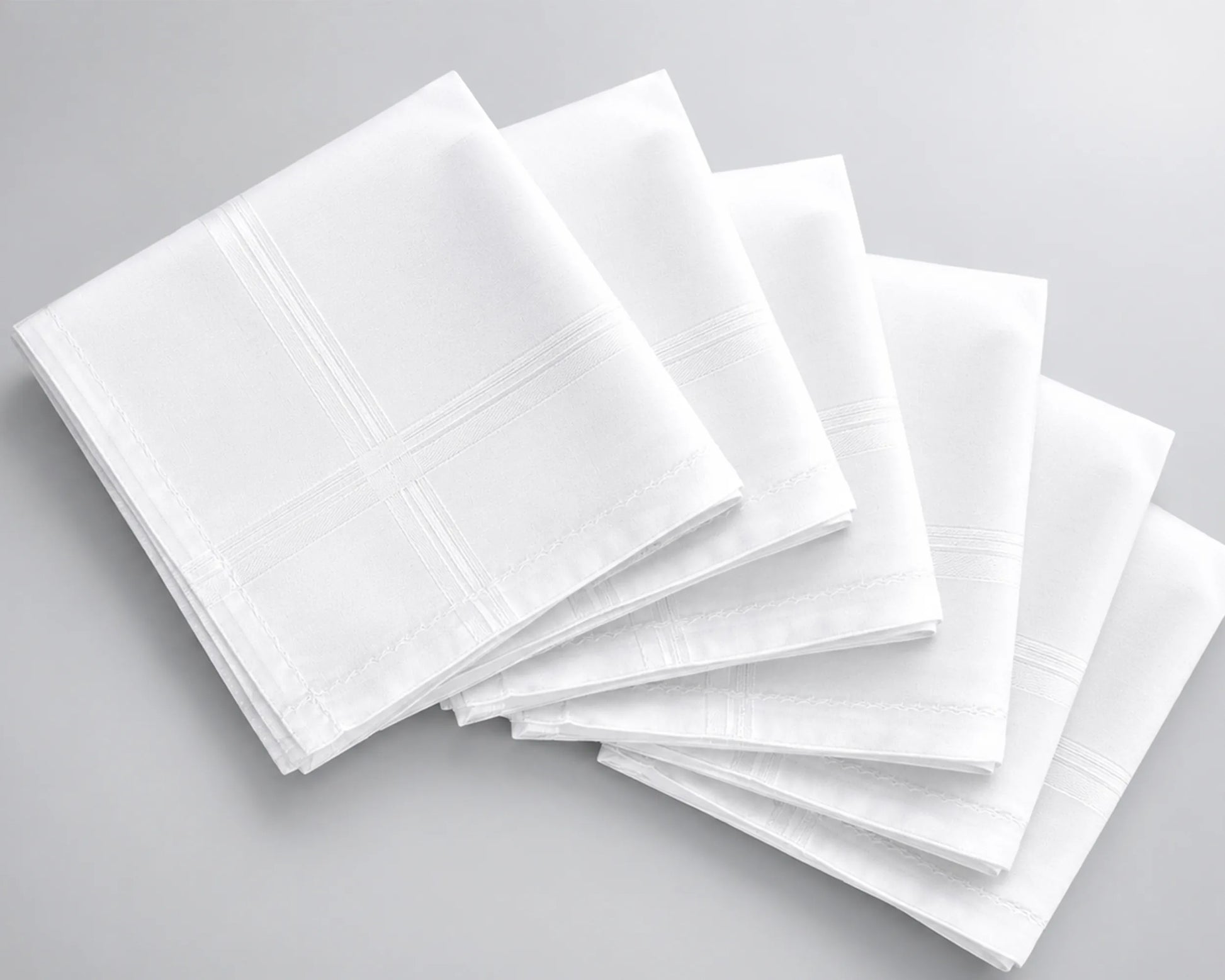 Stack of white hanky on a gray background