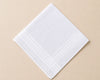 White hanky with subtle pattern on a beige background