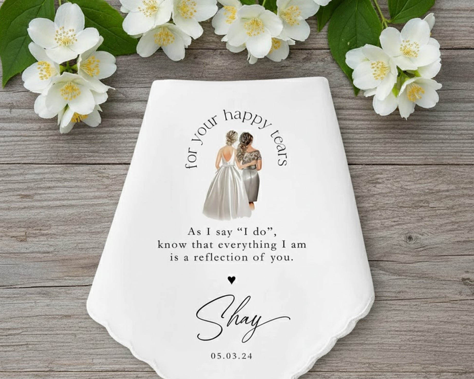 Scalloped white wedding handkerchief featuring a colorful wildflower wreath and the text for your tears of joy for Mick and Carrie.